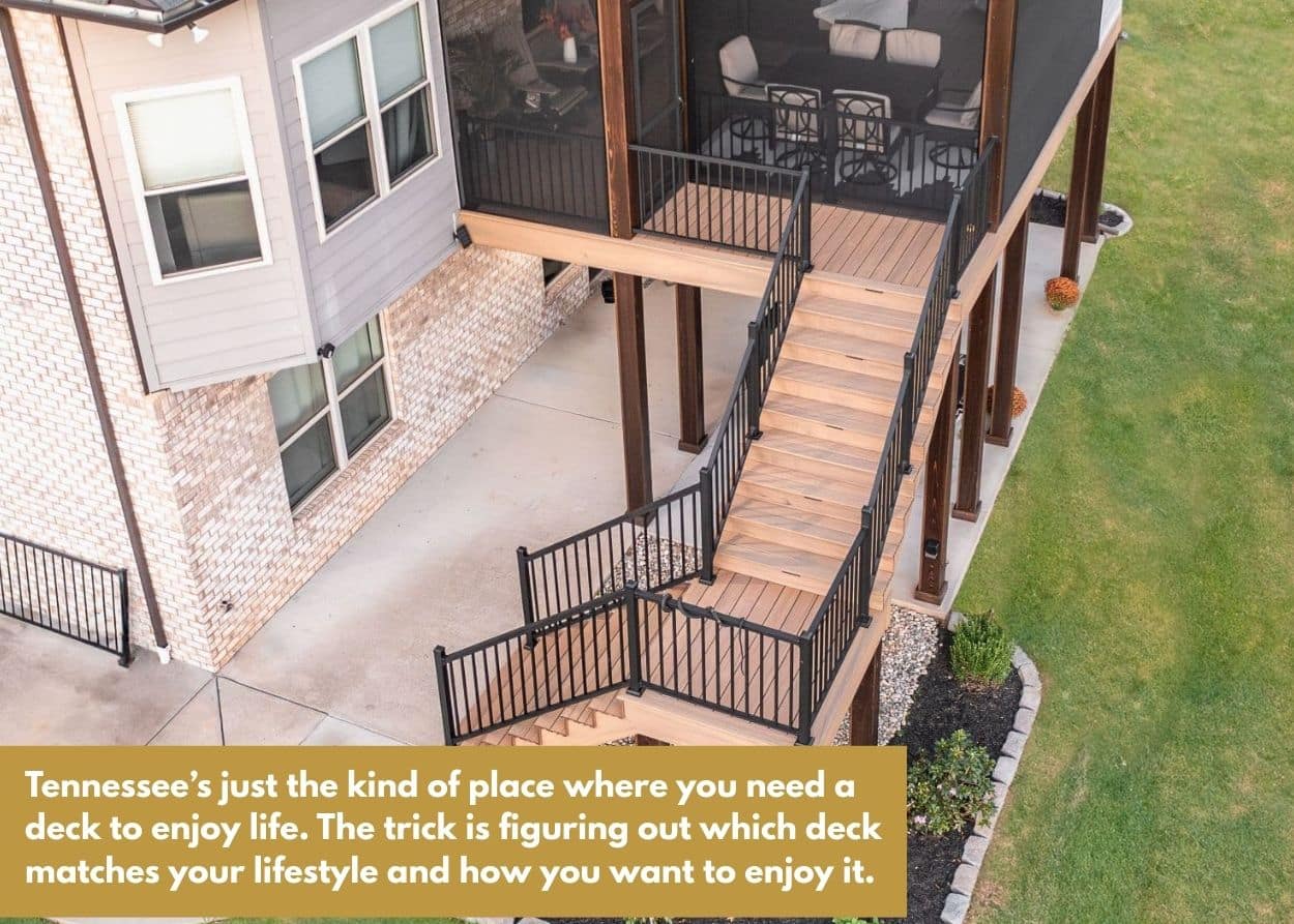 Multi-level deck with black railings and staircase leading to backyard lawn