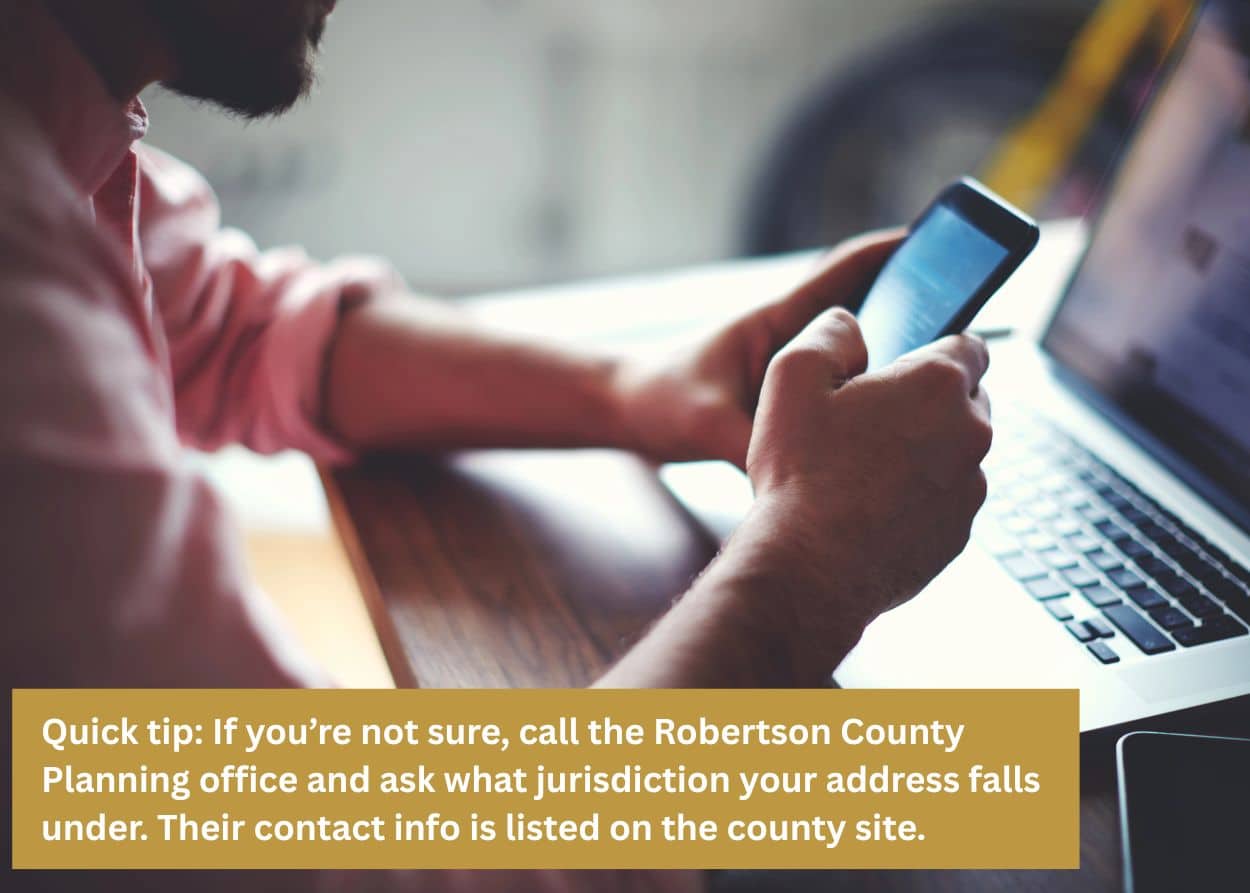 Robertson County TN homeowner reviewing deck building permit requirements on phone and laptop before starting deck construction project