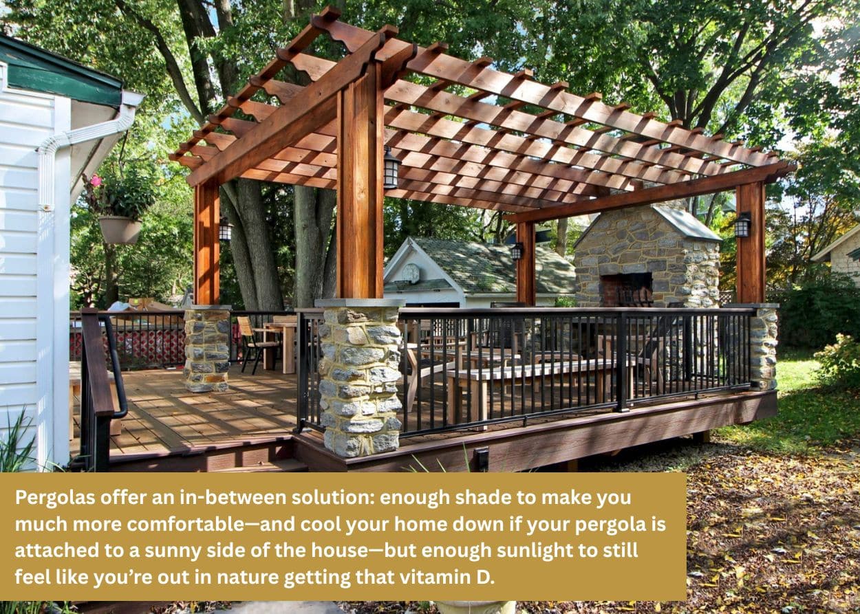 Wooden pergola built over a backyard deck with stone columns providing partial shade and outdoor living space.