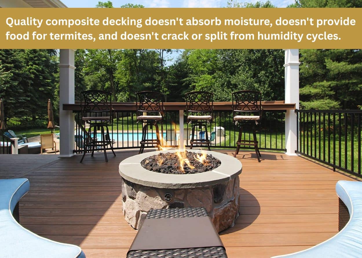 Composite deck in Tennessee with built-in fire pit, bar seating, pergola, and black railing overlooking a wooded backyard