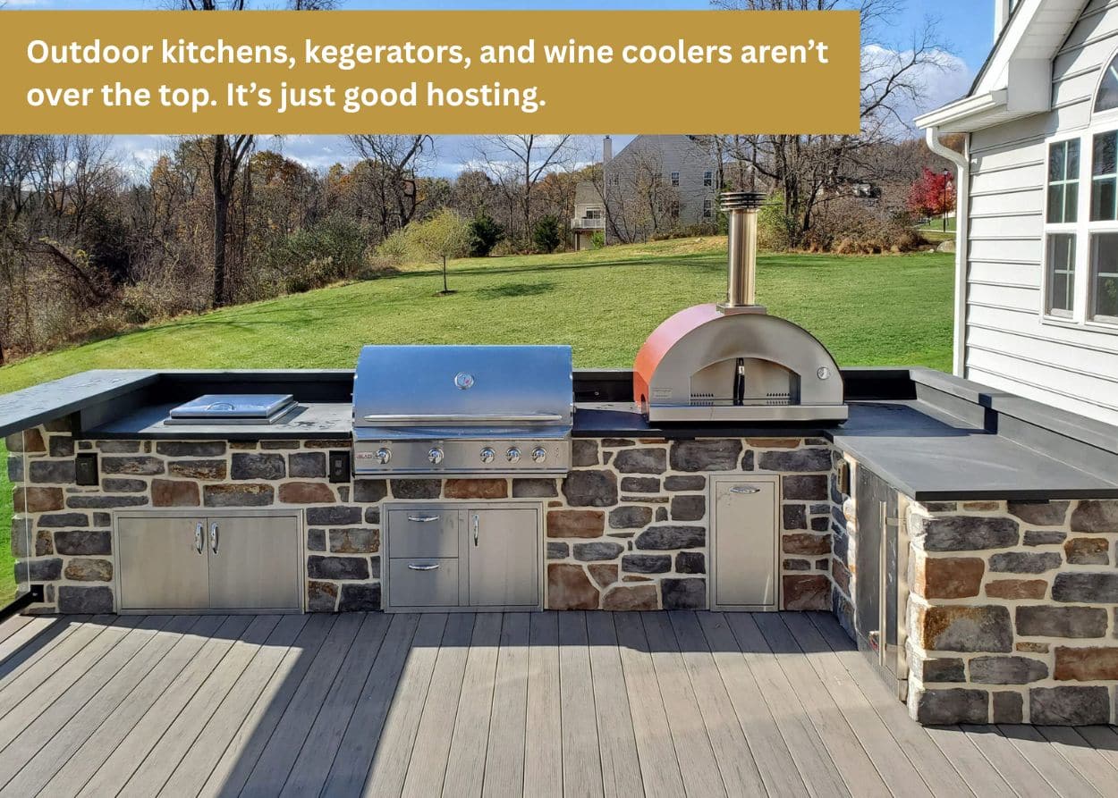 Outdoor kitchen on a deck with built-in grill and pizza oven for entertaining guests