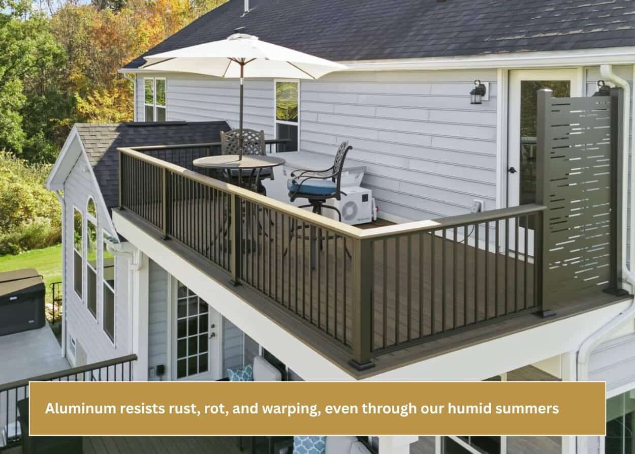 Aluminum spindle deck railing surrounding an elevated composite deck and outdoor seating area